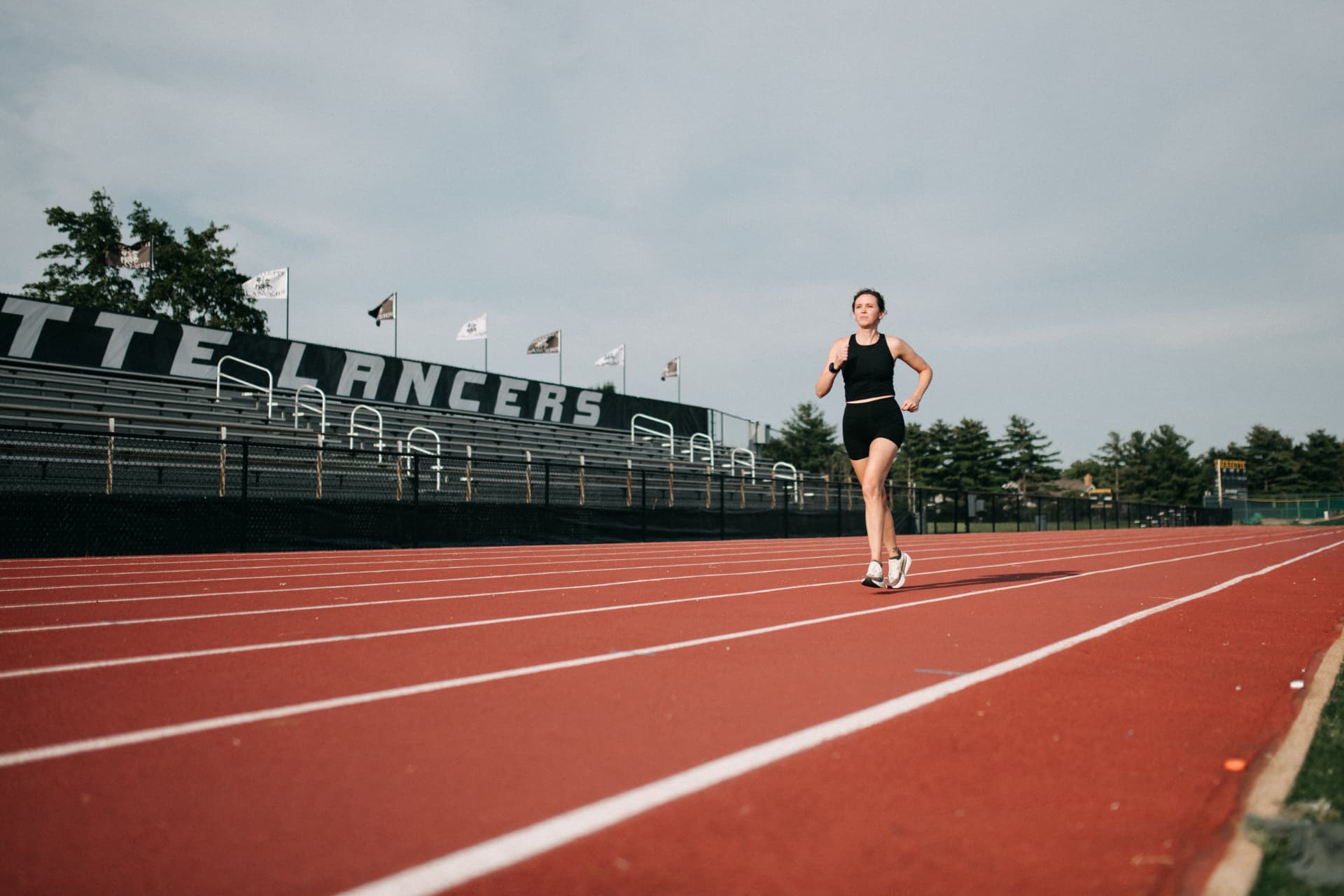 Coach Theresa running on a track in St. Louis